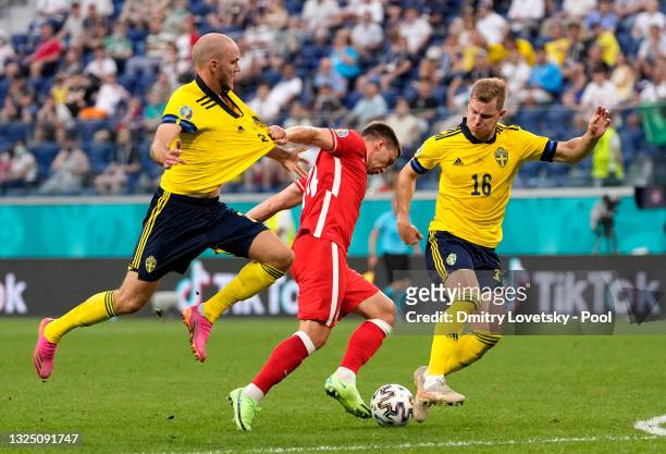 Jakub Swierczok of Poland is challenged by Emil Krafth and Marcus Danielson of Sweden during the UEFA Euro 2020 Championship Group E match between...