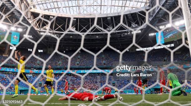 Viktor Claesson of Sweden celebrates after scoring their side's third goal as players of Poland look dejected during the UEFA Euro 2020 Championship...
