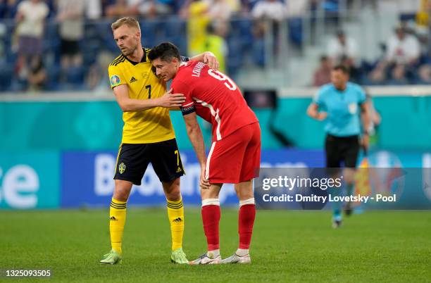 Robert Lewandowski of Poland is embraced by Sebastian Larsson of Sweden following the UEFA Euro 2020 Championship Group E match between Sweden and...