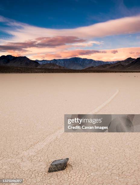 sunrise colors above moving rock at the race track - death valley stock pictures, royalty-free photos & images