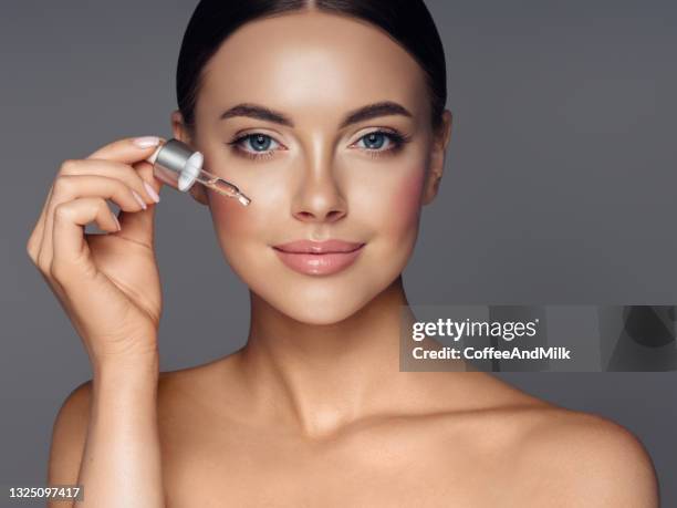 beautiful girl getting skin anti aging treatment - huidkleurig stockfoto's en -beelden