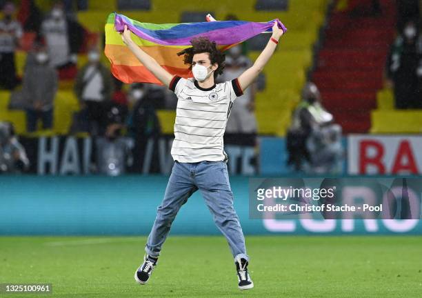 Pitch invader with a rainbow flag is seen on the pitch prior to the UEFA Euro 2020 Championship Group F match between Germany and Hungary at Allianz...