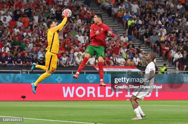 Hugo Lloris of France jumps to catch the ball whilst under pressure from Cristiano Ronaldo of Portugal during the UEFA Euro 2020 Championship Group F...