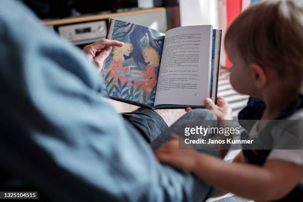In this photo illustration a Hungarian family read tales from the storybook "Wonderland is for Everyone" on June 23, 2021 in Budapest, Hungary....