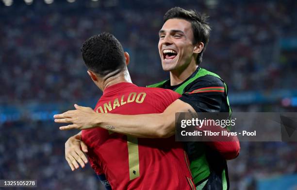 Cristiano Ronaldo of Portugal celebrates with teammate Joao Palhinha after scoring their side's first goal from the penalty spot during the UEFA Euro...