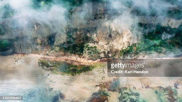 an aerial view of a beach in the mist - stock photo - isle of wight stock pictures, royalty-free photos & images