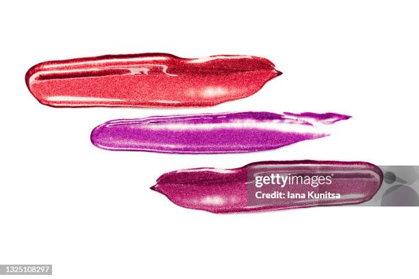 red, pink, burgundy lipstick smears on white background. isolated for design. lip gloss samples are smudged. beauty cosmetic banner. makeup and skin care products. closeup. - pink lipstick smear stock pictures, royalty-free photos & images