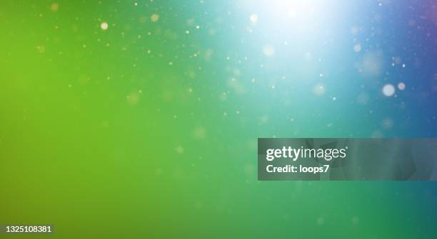 natural green blue gradient background with defocused lights and particles - green background stock illustrations