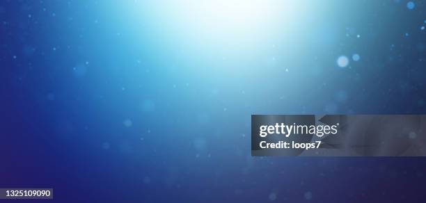 blurred dust particles over gradient blue background - fairy background stock illustrations