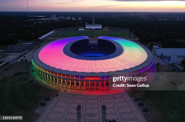 In this aerial view the Olympiastadion stadium stands illuminated in LGBT rainbow colors on June 23, 2021 in Berlin, Germany. Stadiums and landmarks...