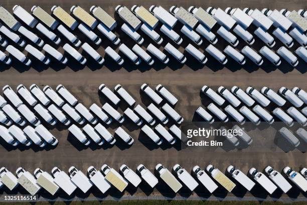 aerial view of white delivery vans - luton stock pictures, royalty-free photos & images
