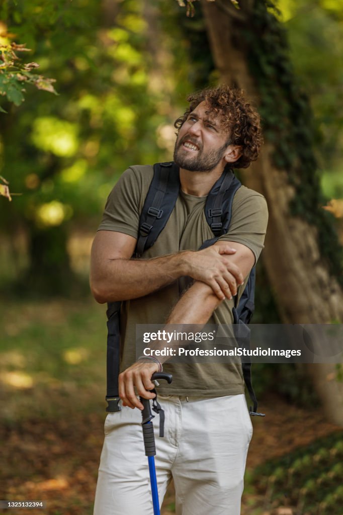 Man is Traveling with Backpack and has Problems with Insects in the Forest.