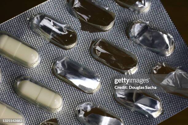 pills in a foil blister pack - blister pack stock-fotos und bilder