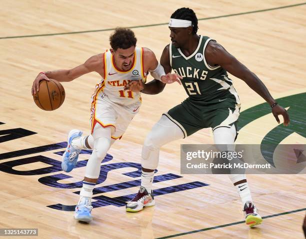 Trae Young of the Atlanta Hawks drives against Jrue Holiday of the Milwaukee Bucks during the second quarter in game one of the Eastern Conference...