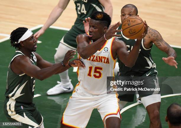 Jrue Holiday of the Milwaukee Bucks pressures Clint Capela of the Atlanta Hawks during the second quarter in game one of the Eastern Conference...