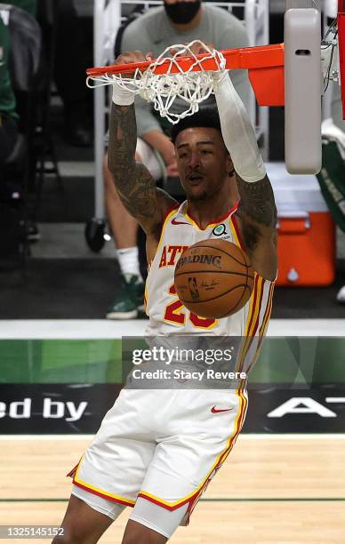 John Collins of the Atlanta Hawks dunks against the Milwaukee Bucks during the second quarter in game one of the Eastern Conference Finals at Fiserv...
