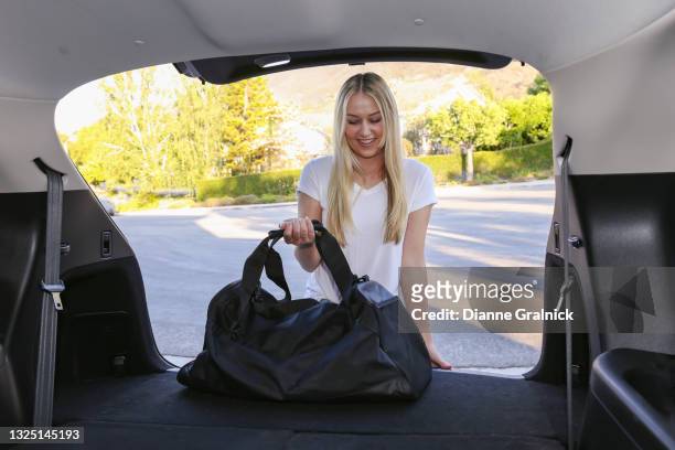 young woman at car trunk with bag - gym bag stock pictures, royalty-free photos & images