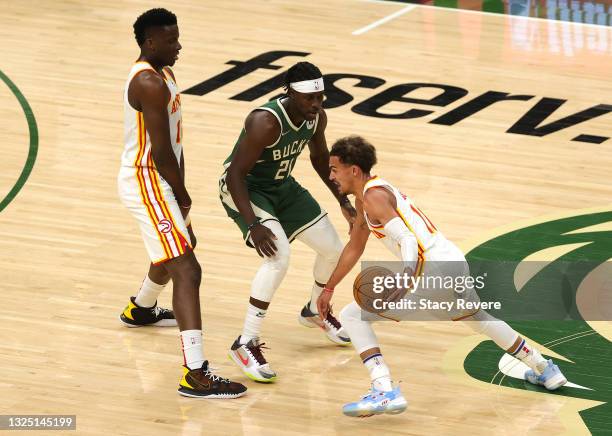 Trae Young of the Atlanta Hawks looks to drive past Jrue Holiday of the Milwaukee Bucks in game one of the Eastern Conference Finals at Fiserv Forum...