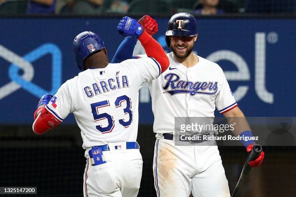 Adolis Garcia of the Texas Rangers celebrates his sixth inning home run with Joey Gallo of the Texas Rangers against the Oakland Athletics at Globe...