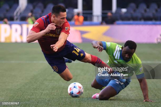 Rubio Rubin of Real Salt Lake and Yeimar Gomez of the Seattle Sounders collide during the first half at Lumen Field on June 23, 2021 in Seattle,...