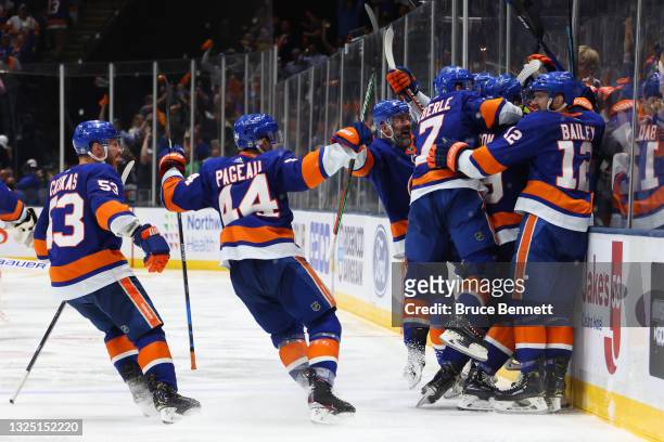 The New York Islanders celebrate after their 3-2 overtime victory against the Tampa Bay Lightning in Game Six of the Stanley Cup Semifinals during...