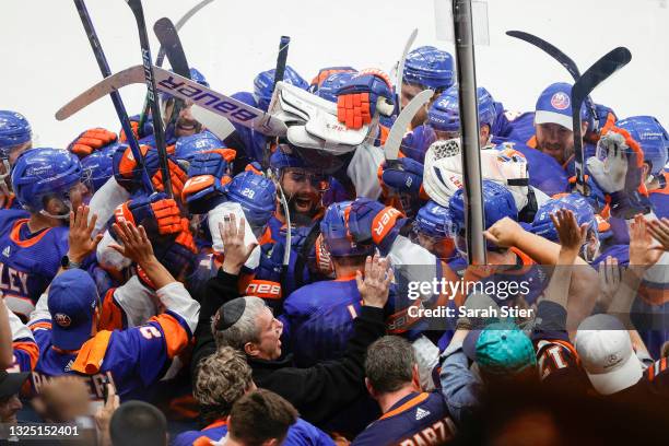 The New York Islanders celebrate after their 3-2 overtime victory against the Tampa Bay Lightning in Game Six of the Stanley Cup Semifinals during...