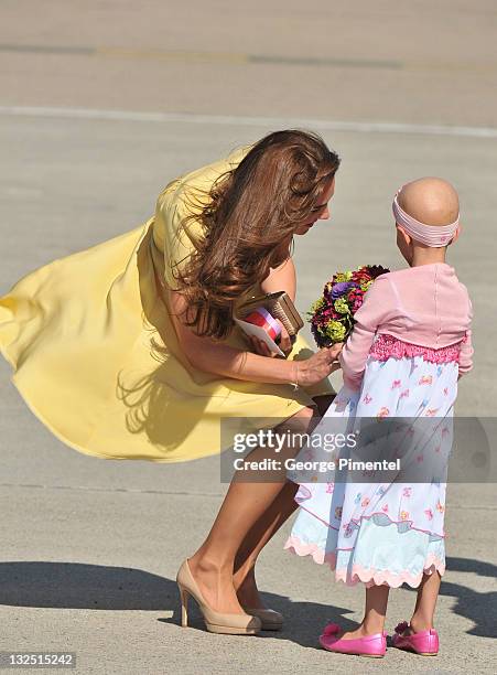 Catherine, Duchess of Cambridge receives a flowers from six-year-old Diamond Marshall from ""Make a Wish Foundation"" who is suffering from Stage 4...