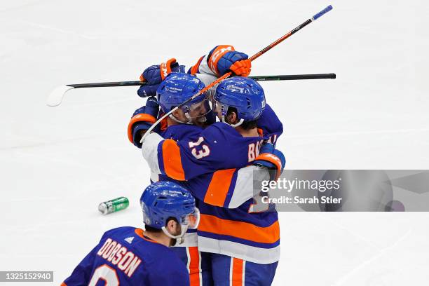 Anthony Beauvillier of the New York Islanders is congratulated by Mathew Barzal after scoring the game-winning goal during the first overtime period...