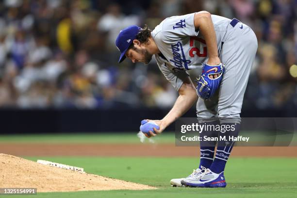 Trevor Bauer of the Los Angeles Dodgers uses a rosin bag during the fourth inning of a game against the San Diego Padres at PETCO Park on June 23,...