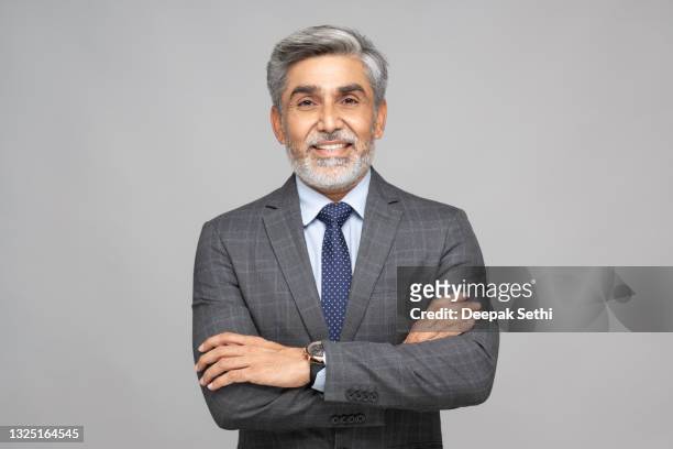 portrait of mature business men wearing suit standing against gray background:- stock photo - chief executive officer stock pictures, royalty-free photos & images