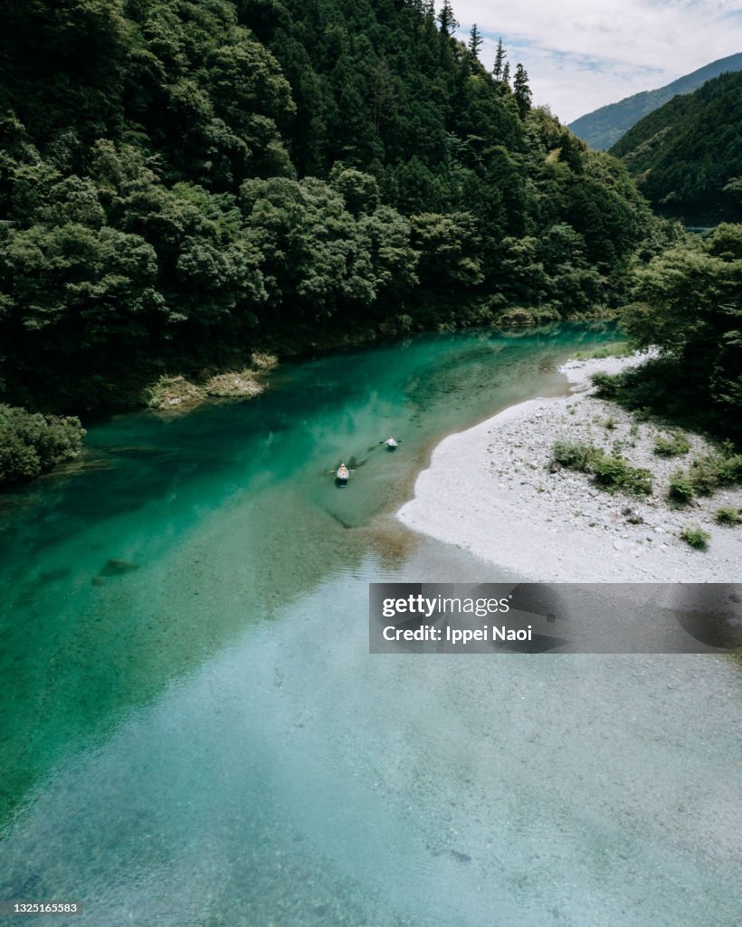 Aerial view of clear river water with kayaks, Japan