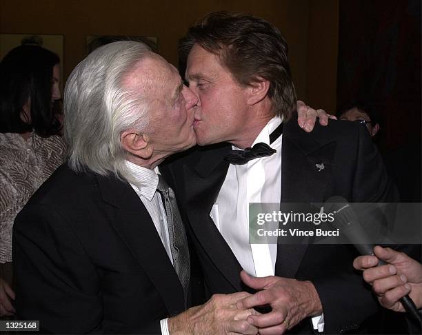 Actor Kirk Douglas kisses his son, actor Michael Douglas, as they attend the Simon Wiesenthal Center''s National Tribute Dinner honoring Michael...