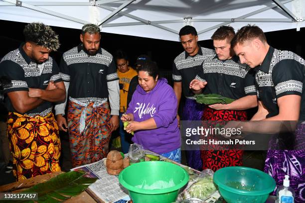 Hoskins Sotutu, Patrick Tuipulotu, Tupou Vaa'i, Ethan de Groot and George Bridge of the All Blacks help prepare a Samoan Umu at Fetu Pupula Place on...