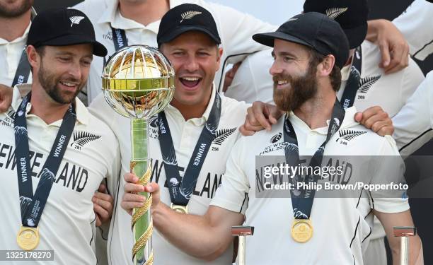 Kane Williamson of New Zealand holds the Test mace aloft with team mates Devon Conway and Neil Wagner after New Zealand won the ICC World Test...