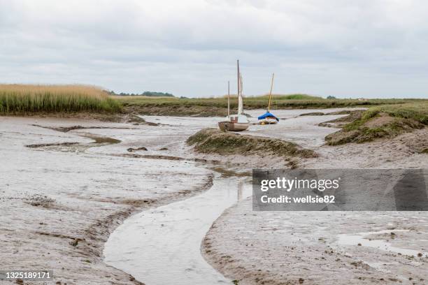 low tide at brancaster staithe - mud flat stock pictures, royalty-free photos & images