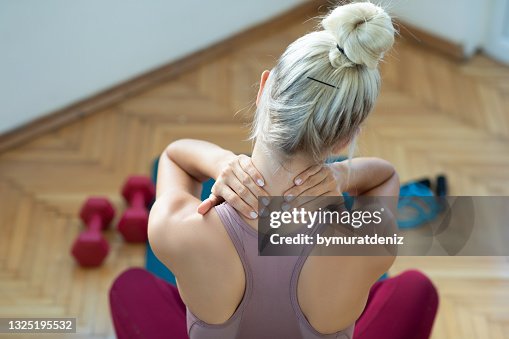 Woman rubbing her neck Woman rubbing her neck