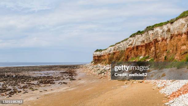 distinctive striped cliffs at old hunstanton - hunstanton stock pictures, royalty-free photos & images