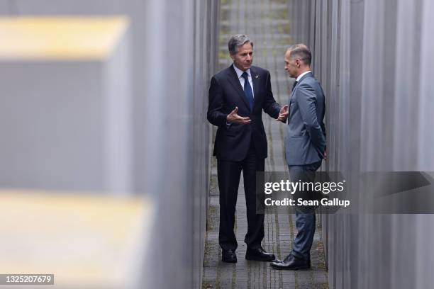 Secretary of State Antony Blinken and German Foreign Minister Heiko Maas speak while standing among stellae of the Memorial to the Murdered Jews of...