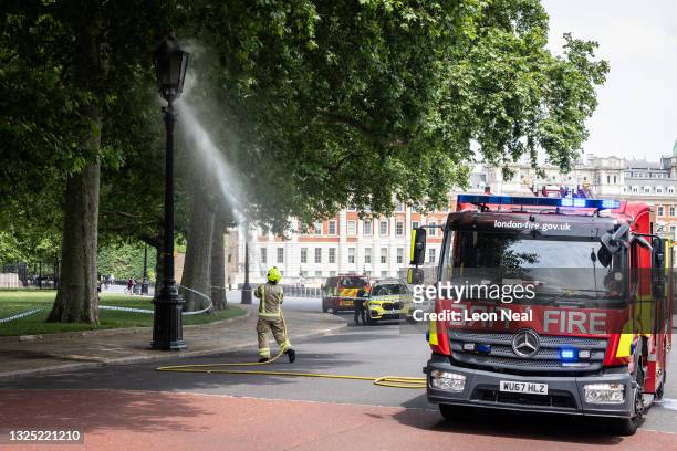 Firefighters attend a blaze within a gas lamp behind Downing Street after it malfunctioned and ignited on June 24, 2021 in London, England.