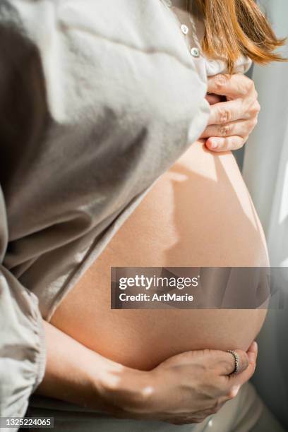 pregnant woman's belly close up - pregnant belly stock pictures, royalty-free photos & images