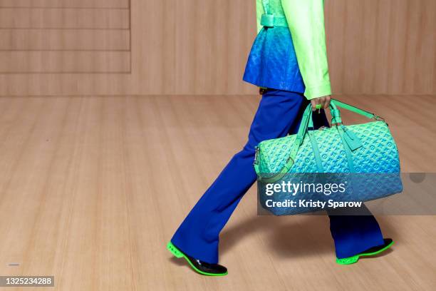 In this image released on June 24th, a model, bag detail, walks the runway during the Louis Vuitton Menswear Spring Summer 2022 show as part of Paris...
