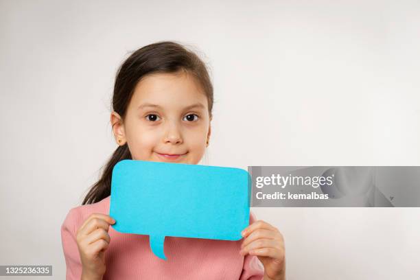 little girl holding speech balloon - kids placard stock pictures, royalty-free photos & images