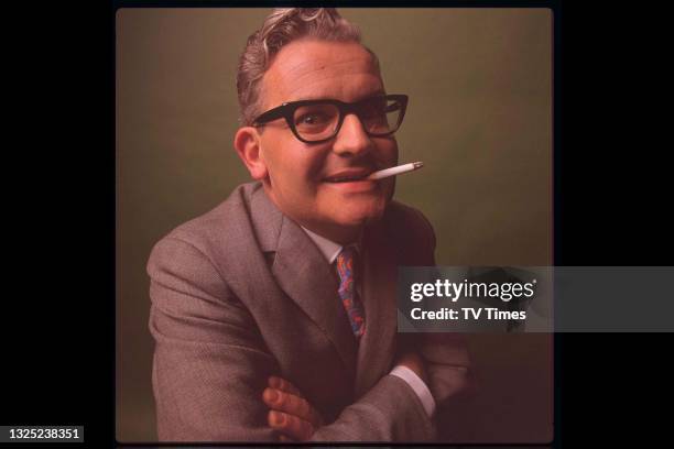 Comedian and writer Ronnie Barker smoking a cigarette, circa 1968.