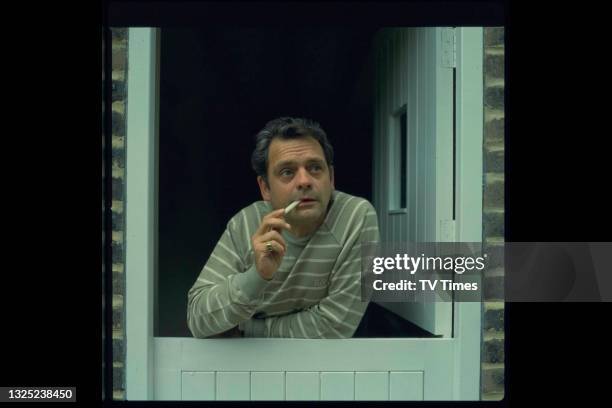 Actor David Jason leaning out of a stable door, circa 1983.