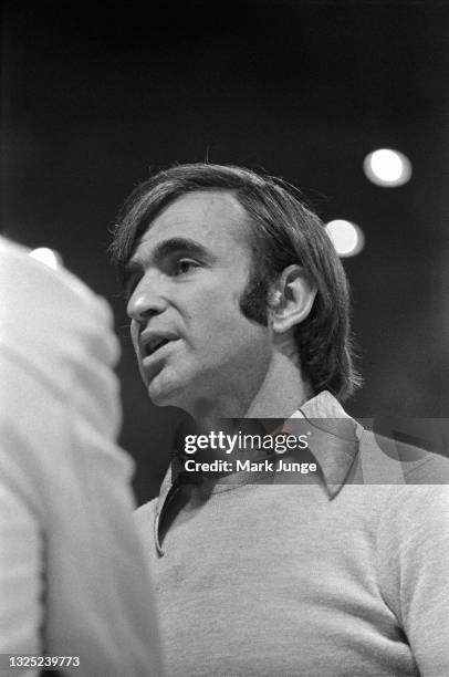 Denver Nuggets General Manager Carl Scheer talks to an unidentified person during an NBA basketball game against the Boston Celtics at McNichols...