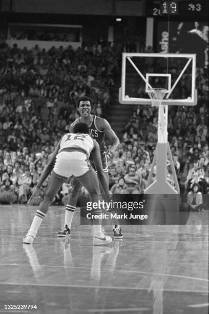 Boston Celtics guard Jo Jo White is guarded near the half-court line by Denver Nuggets guard Ted McClain during an NBA basketball game at McNichols...
