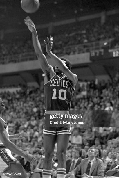 Boston Celtics guard Jo Jo White releases a jump shot near his team’s bench during an NBA basketball game against the Denver Nuggets at McNichols...