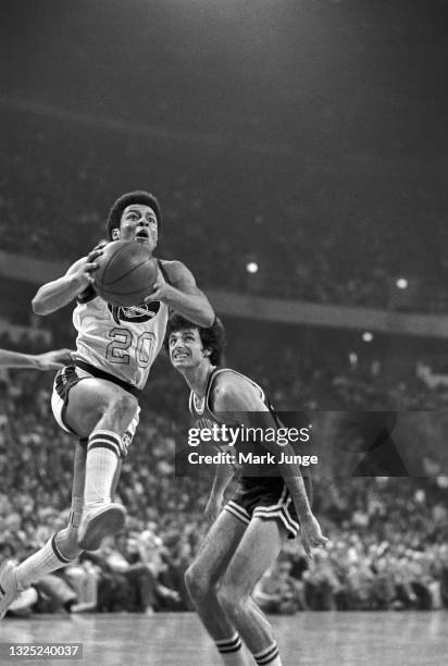 Denver Nuggets guard Mack Calvin drives to the hoop past Boston Celtics guard Kevin Stacom during a game against the Boston Celtics at McNichols...