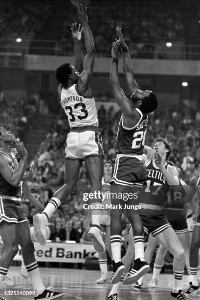 Denver Nuggets forward David Thompson shoots a jump shot in the key over Boston Celtics forward Fred Saunders during an NBA basketball game at...