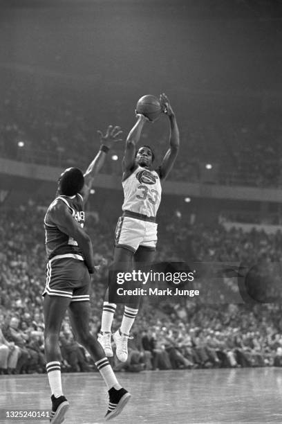 Denver Nuggets forward David Thompson shoots a fall-away jumper in front of Boston Celtics forward Fred Saunders during a game at McNichols Arena on...